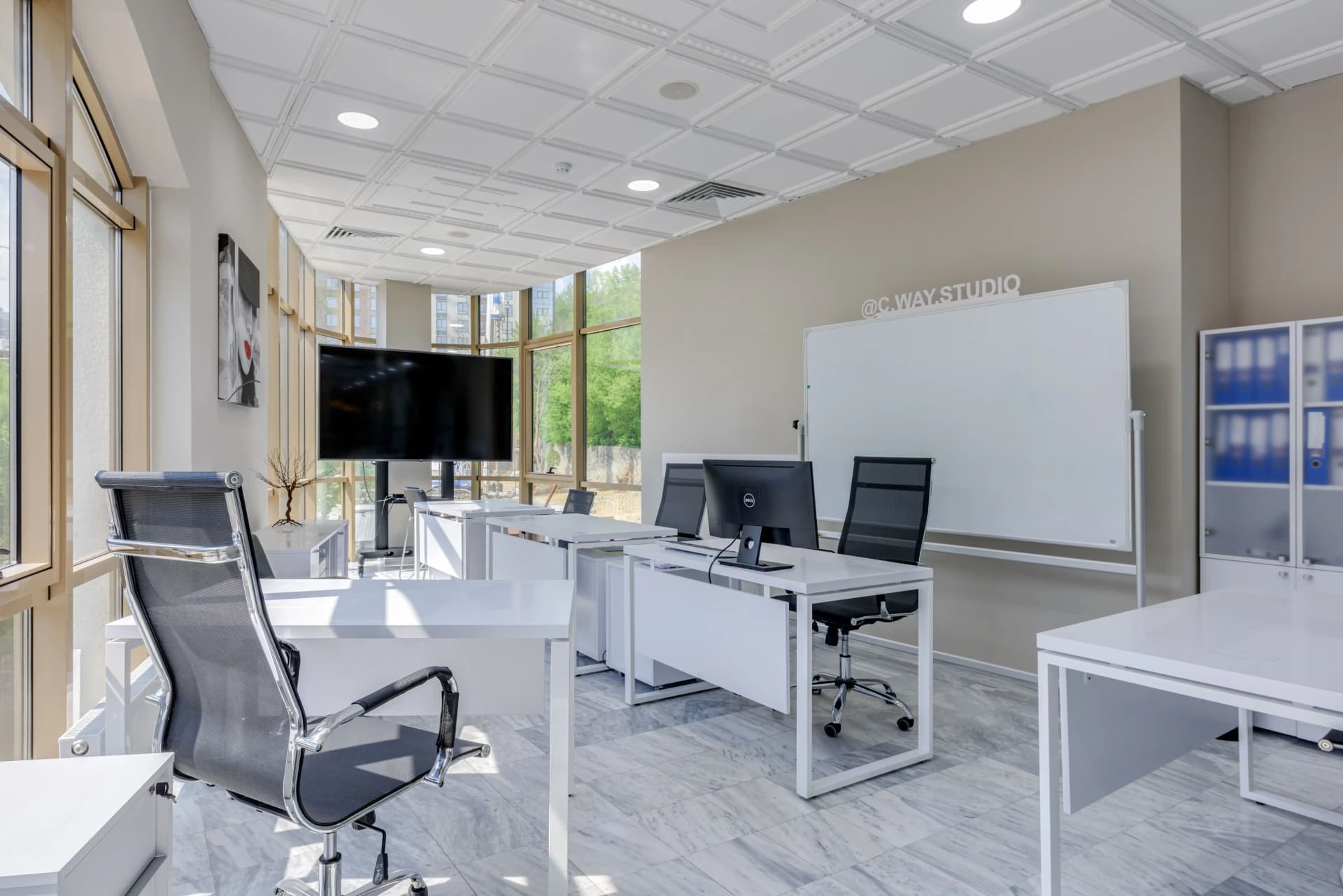 Cat B office fit-out showing carpet flooring, task lighting, glass manifestation, workstations, kitchenette and reception joinery in a UK commercial office.