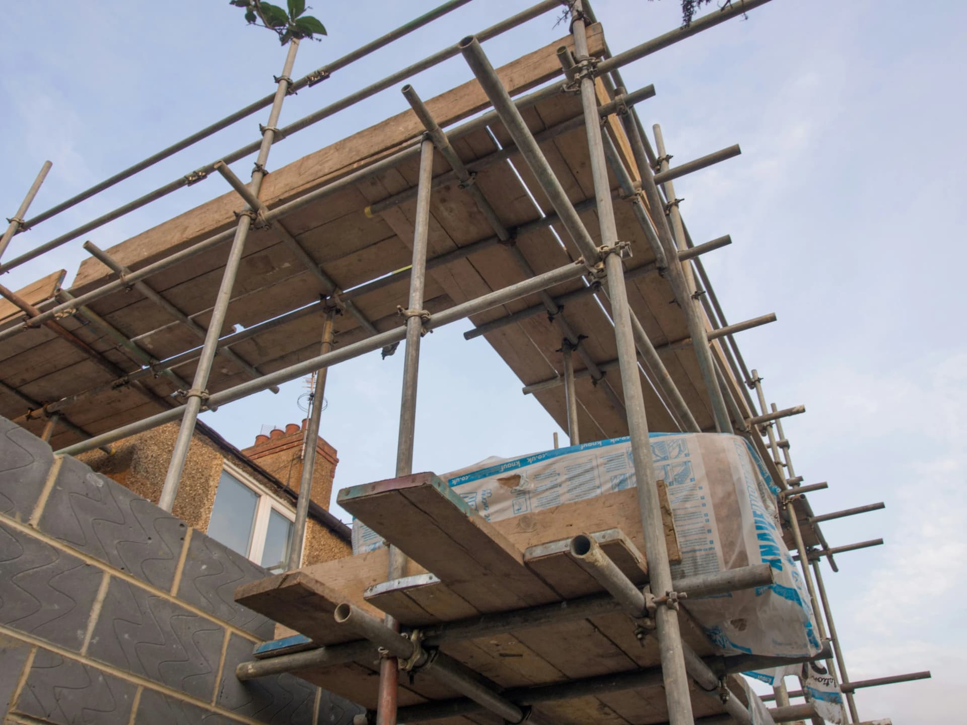 Workers refreshing the exterior surfaces of a commercial property during a UK redecoration project.