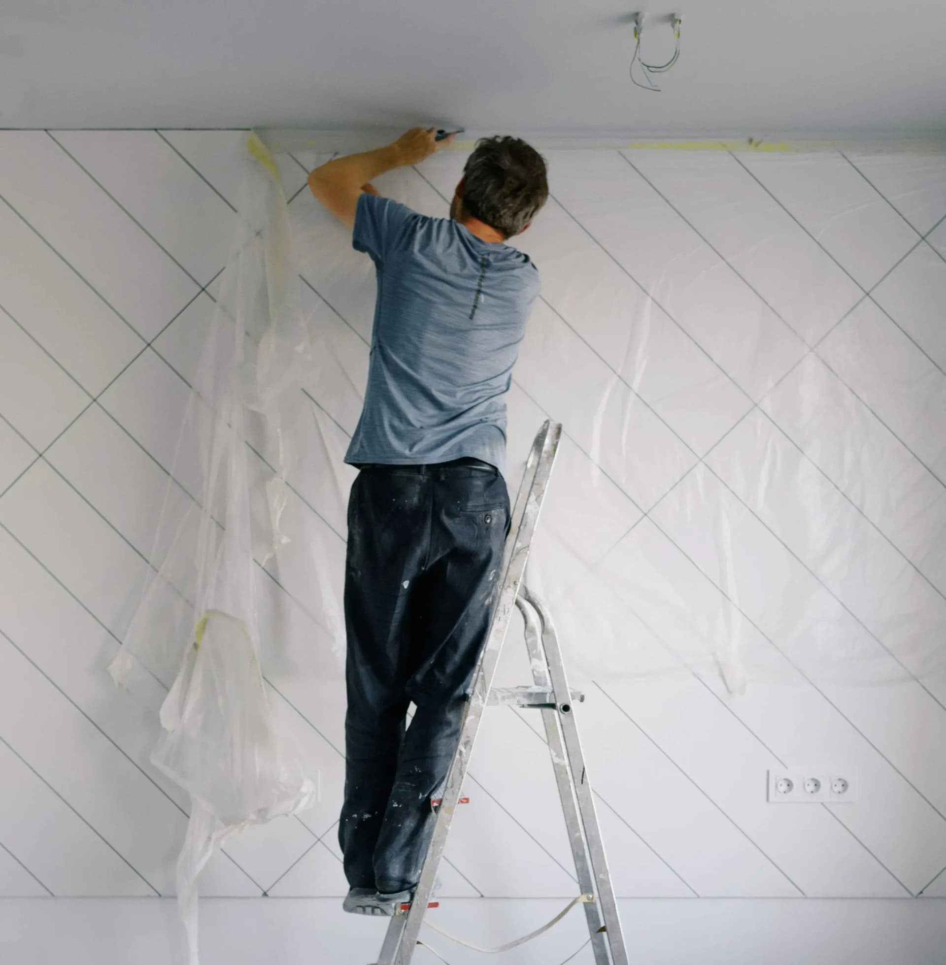 Professional team installing decorative wallpaper and wall finishes in a UK commercial property.
