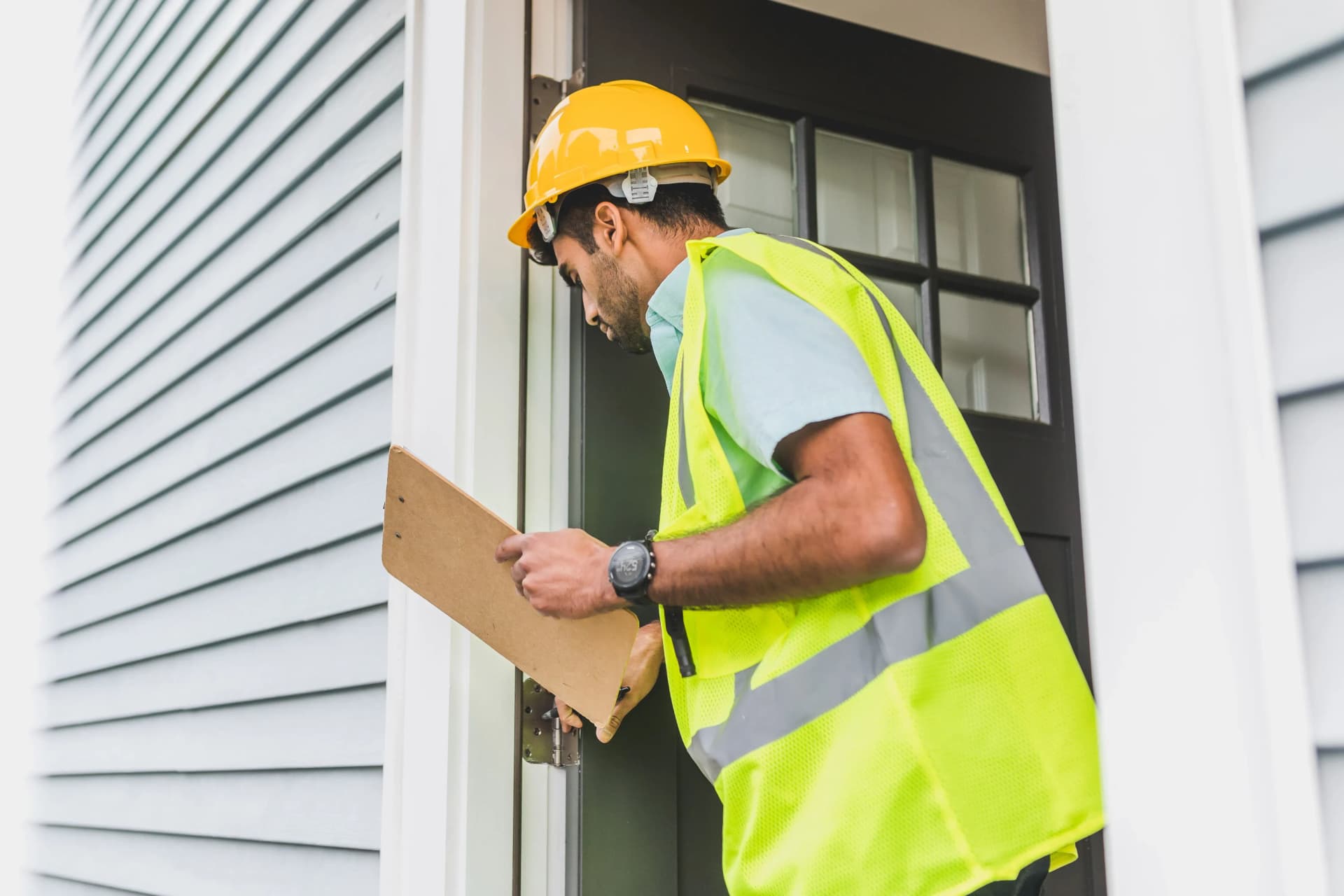Worker inspecting a wall during a compartmentation survey