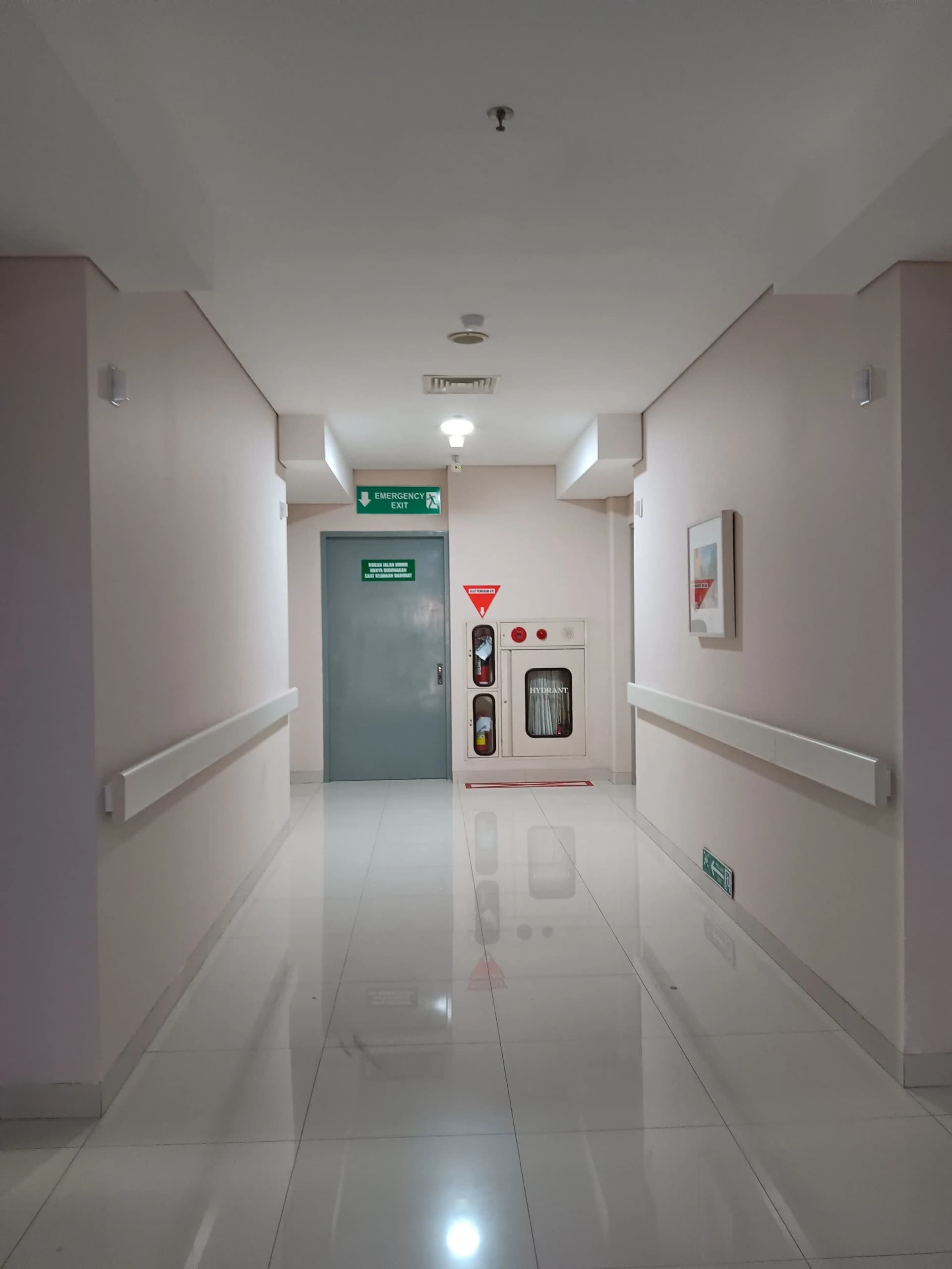Emergency light visible above a door in a building hallway