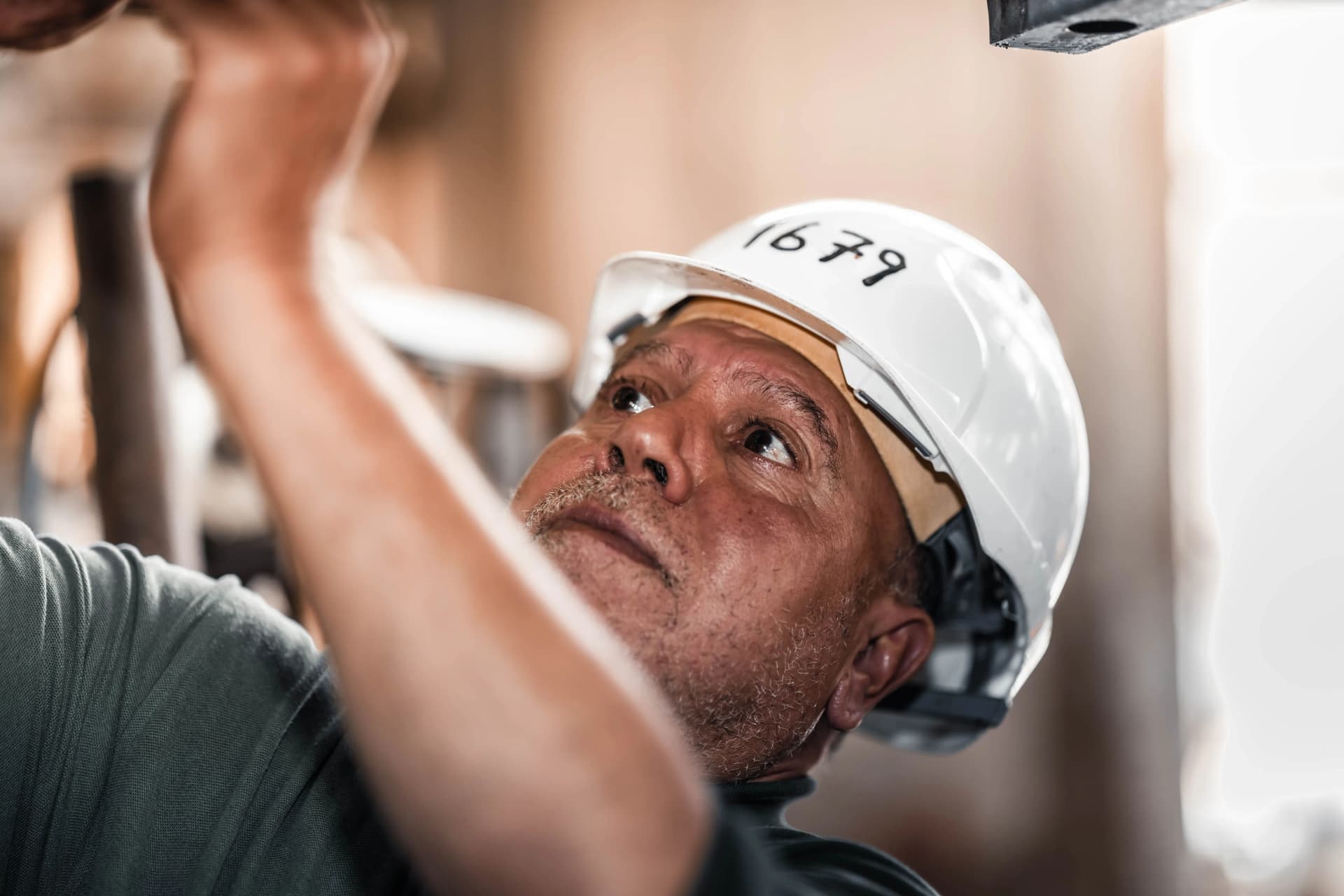 Experienced worker repairing an emergency light