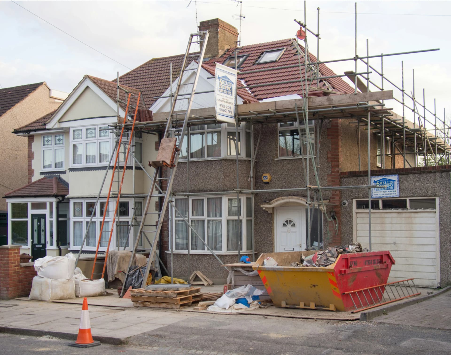 Professional team carrying out external redecoration work on a commercial building in the UK.