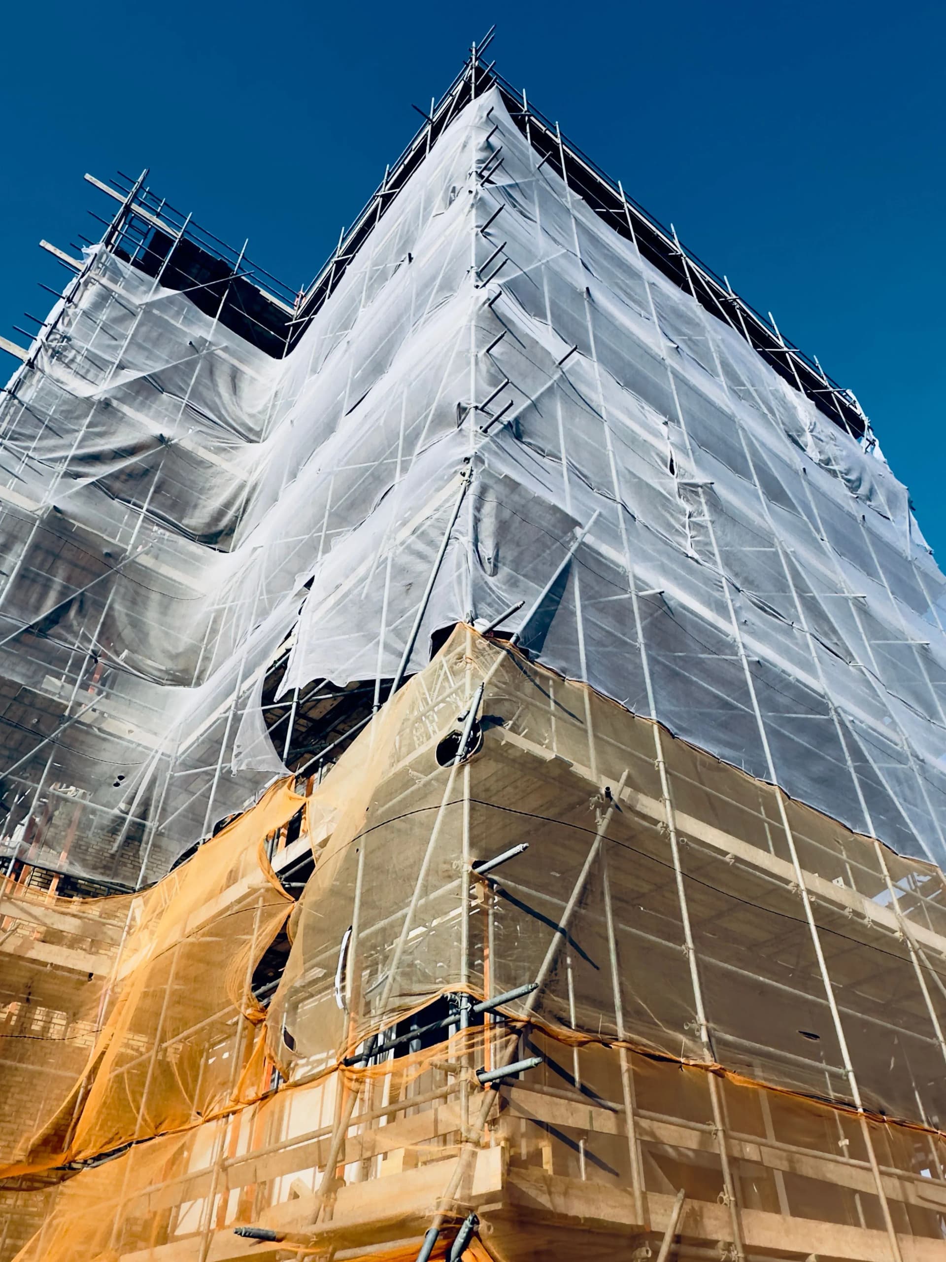 Facade retention services supporting an existing building façade during redevelopment