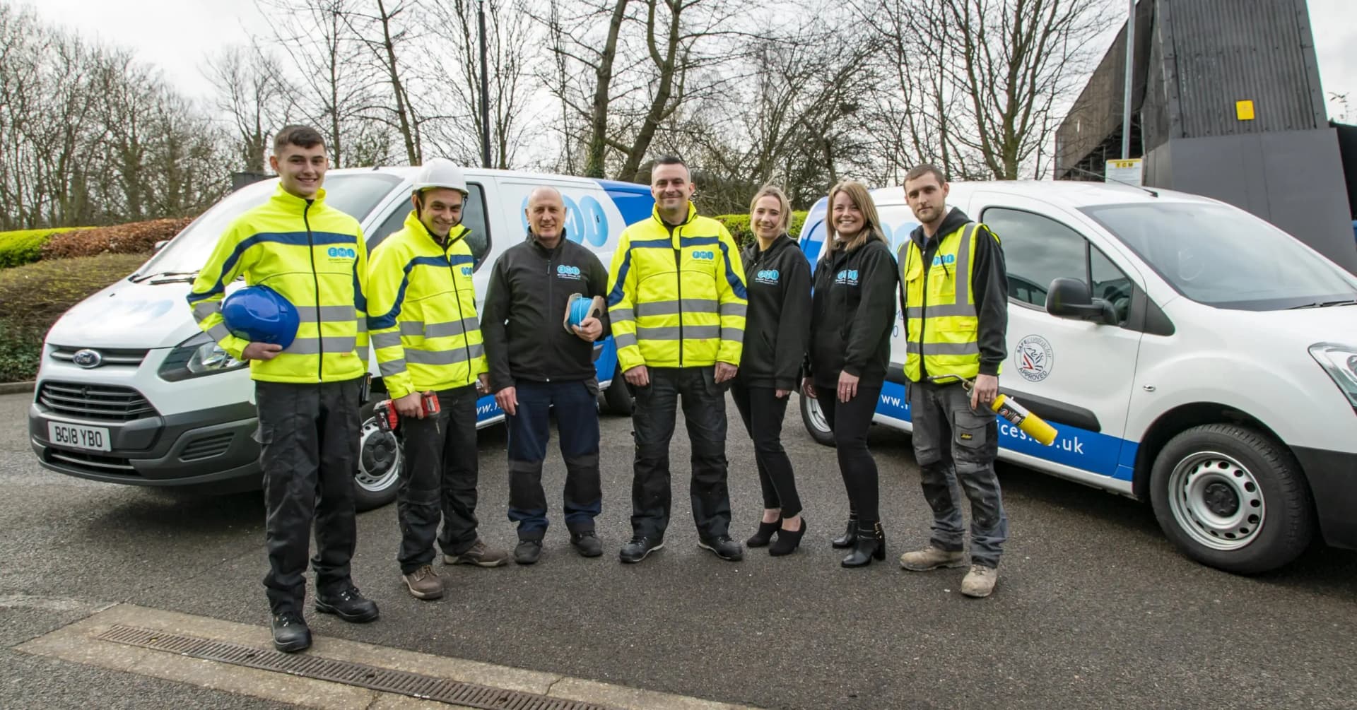 Professional facility management team standing together on site.