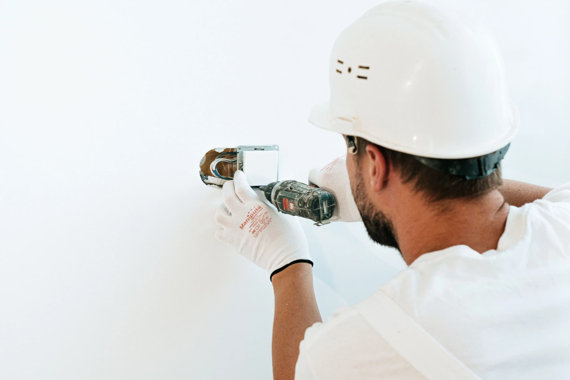 Worker installing a fire alarm system