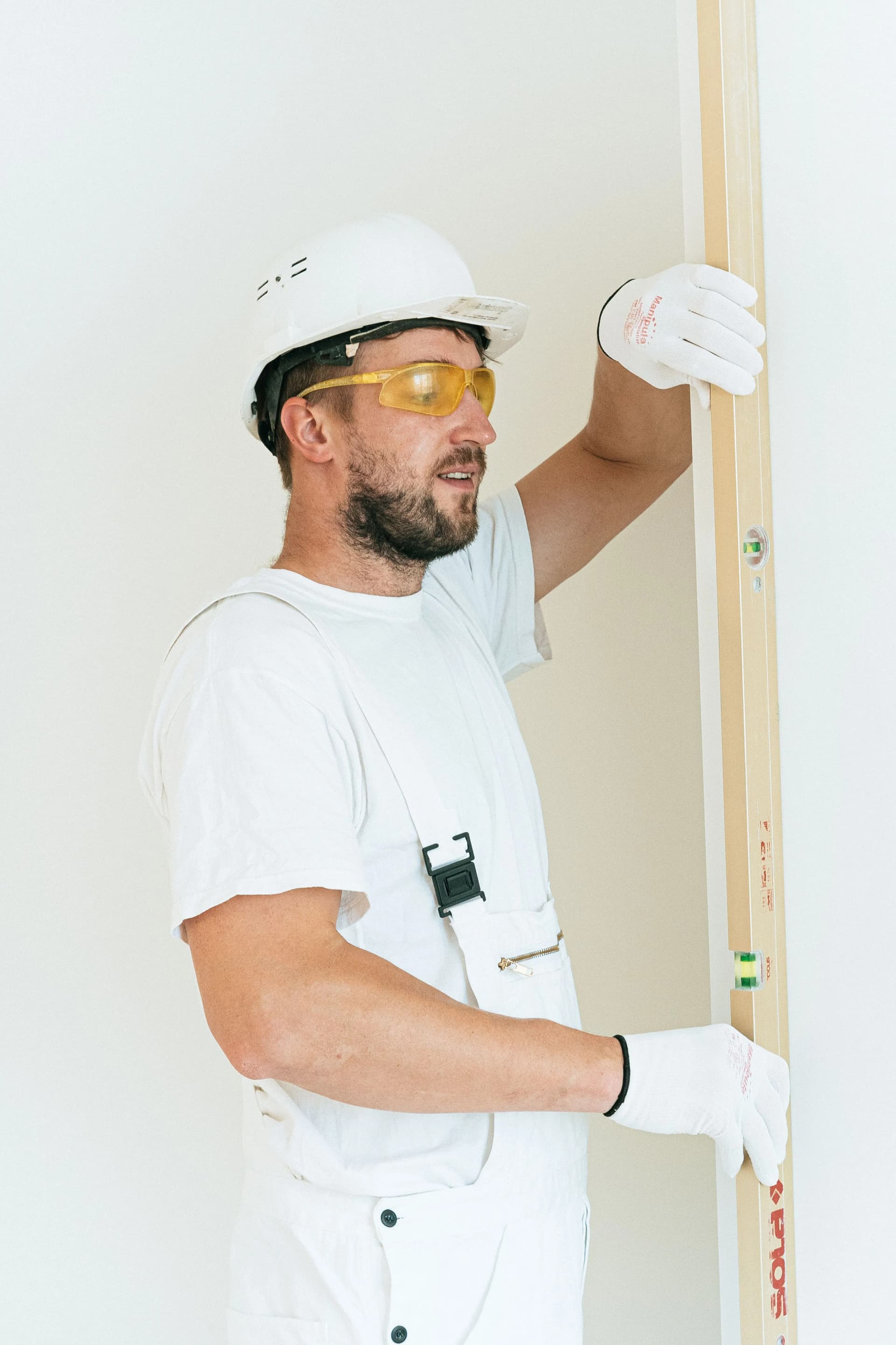 Worker installing a fire door as part of fire door installation works