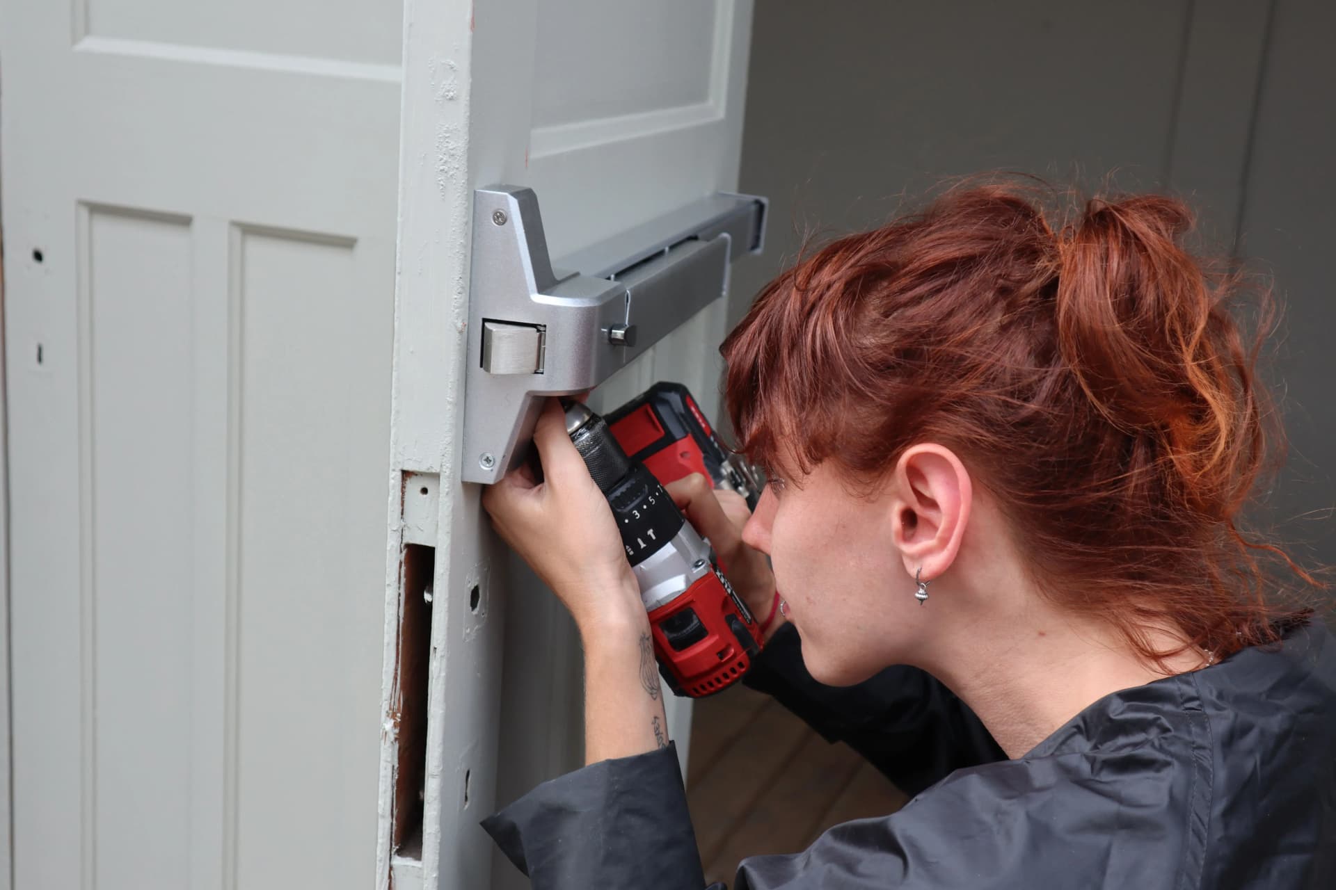 Professional installing a fire door during installation works