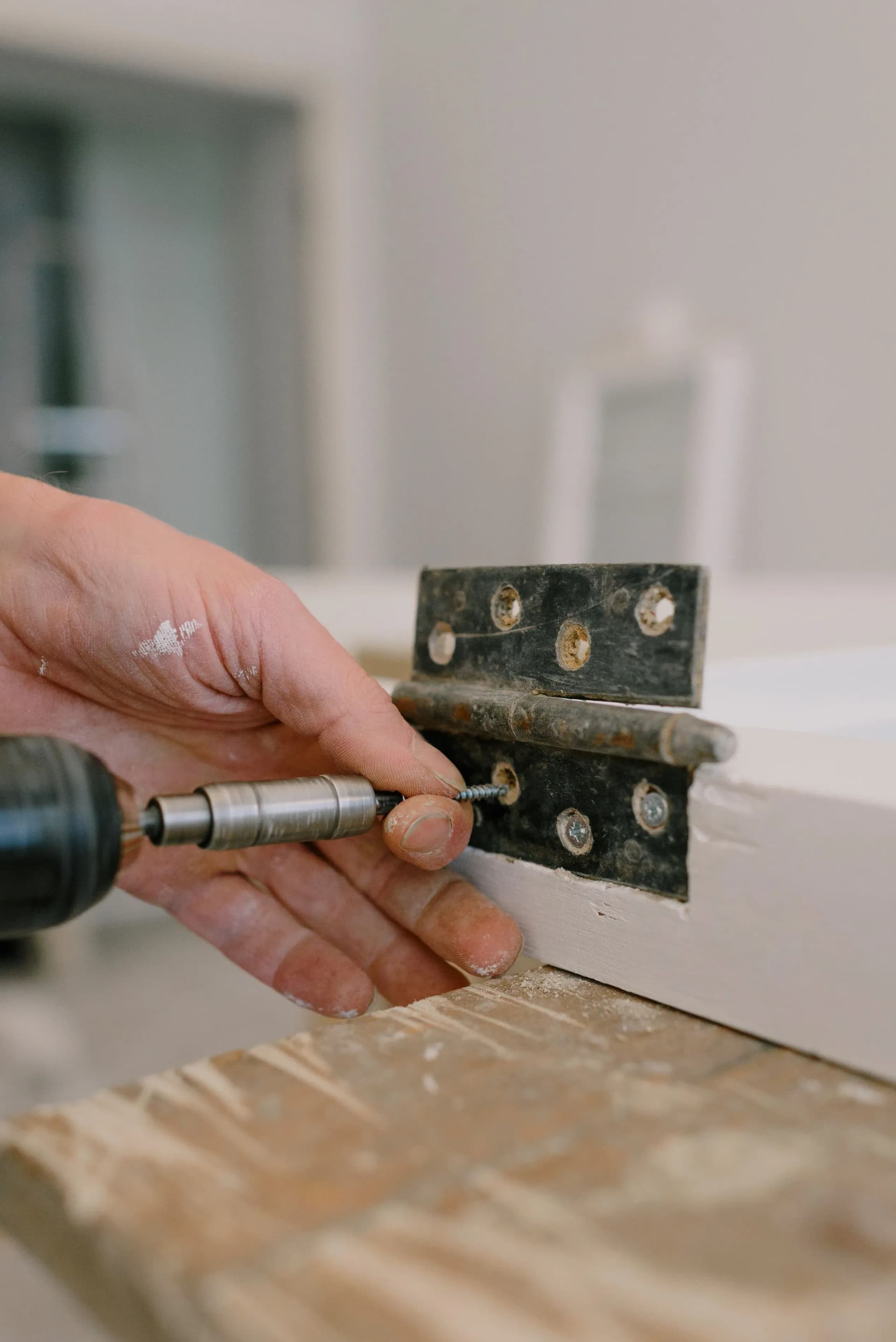 Worker repairing a fire door during remedial works