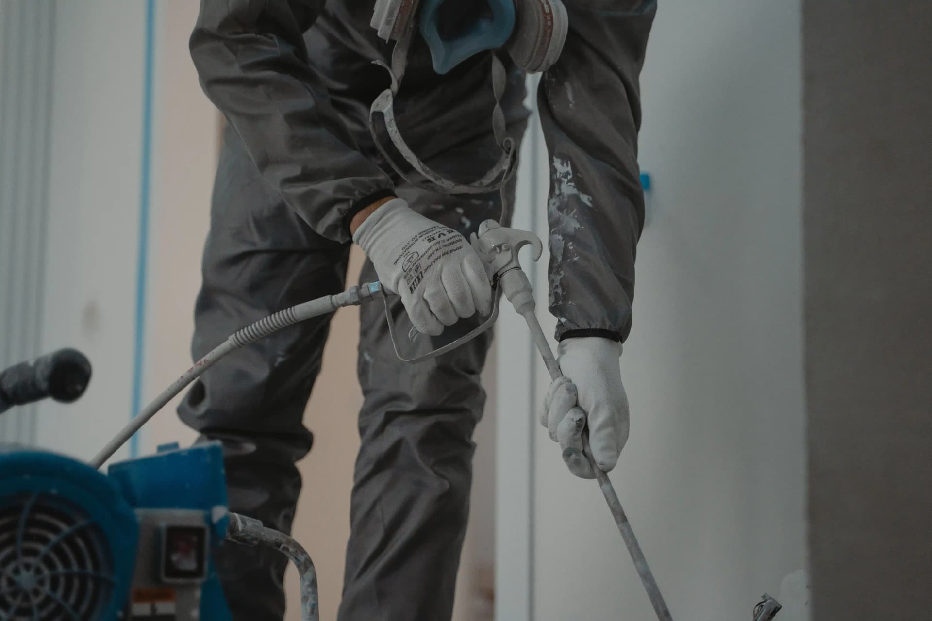 Industrial floor marking and safety zoning being applied in a UK warehouse.