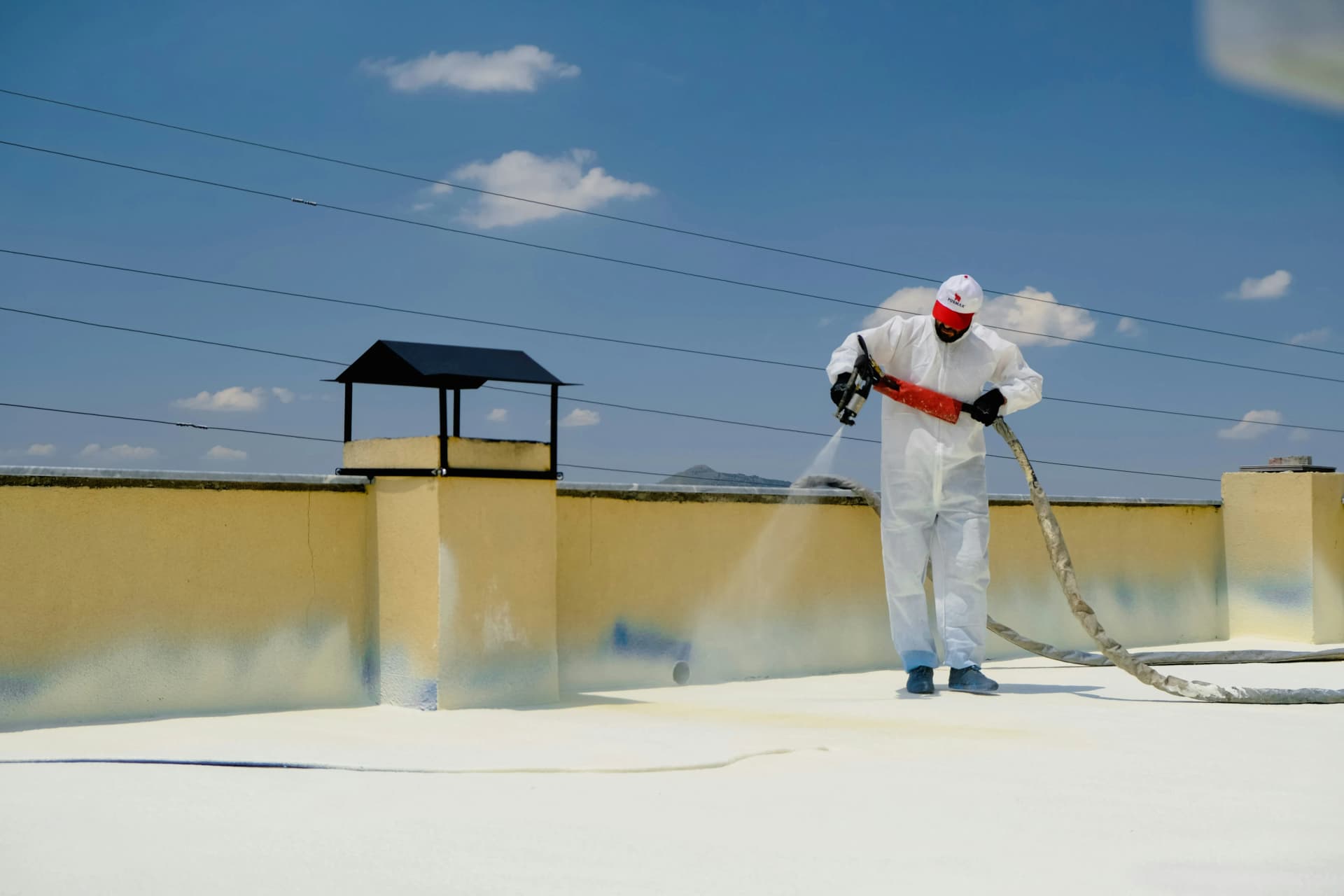 Professional team applying intumescent paint to structural steelwork in a UK commercial building