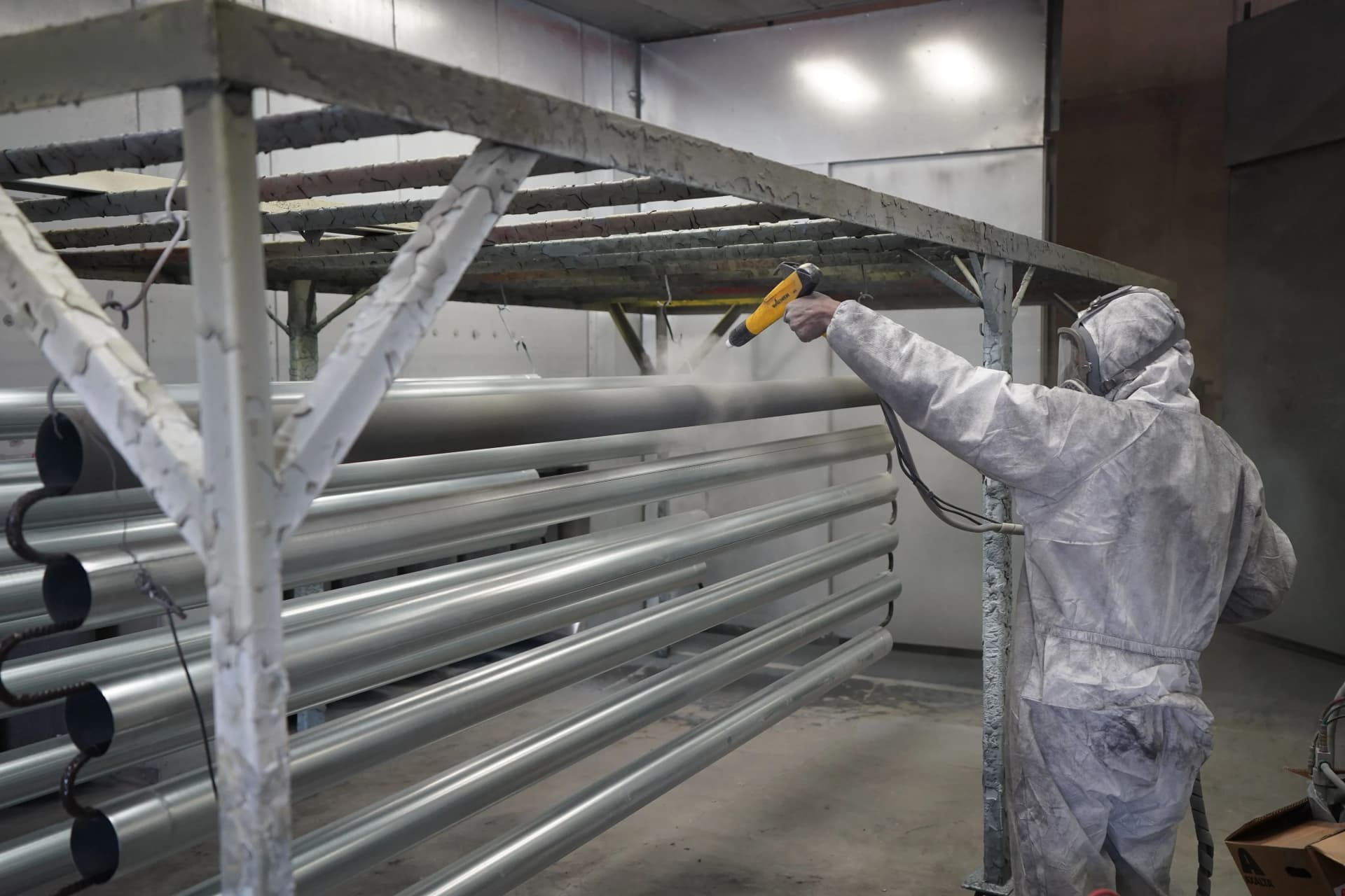 Worker applying intumescent coating to structural steelwork