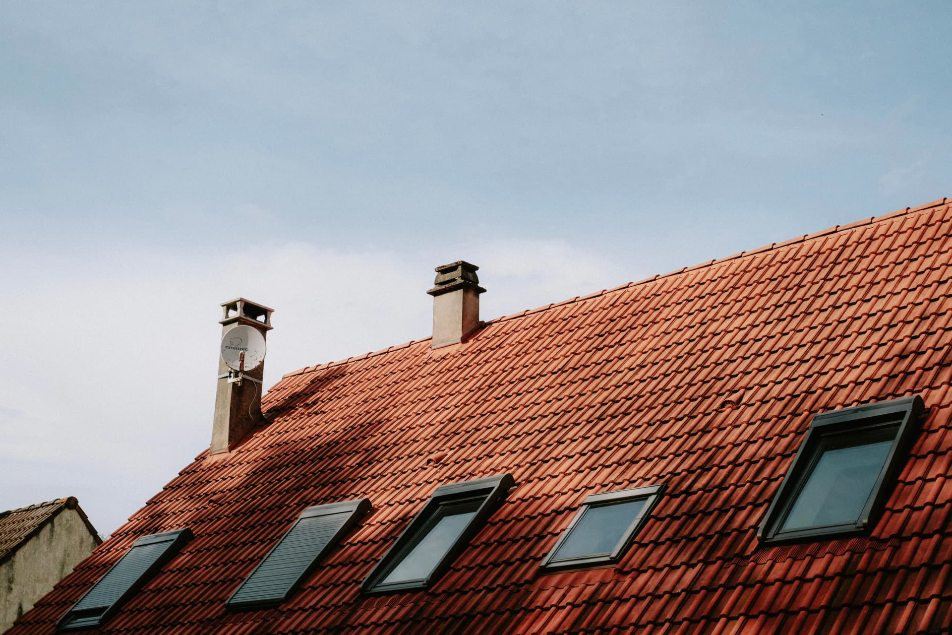 Roofer carrying out pitched roof installation on a residential property