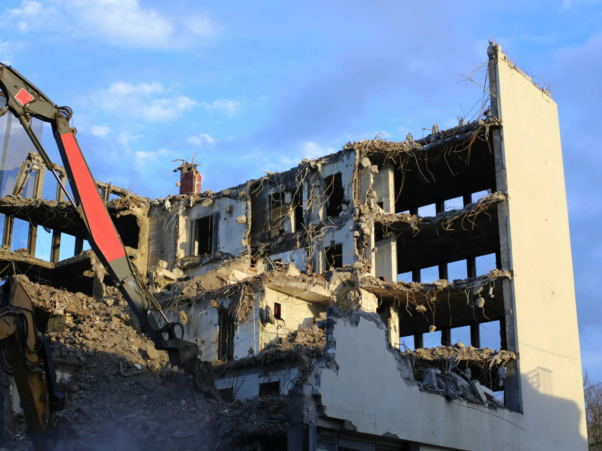Workers dismantling industrial plant and machinery on site