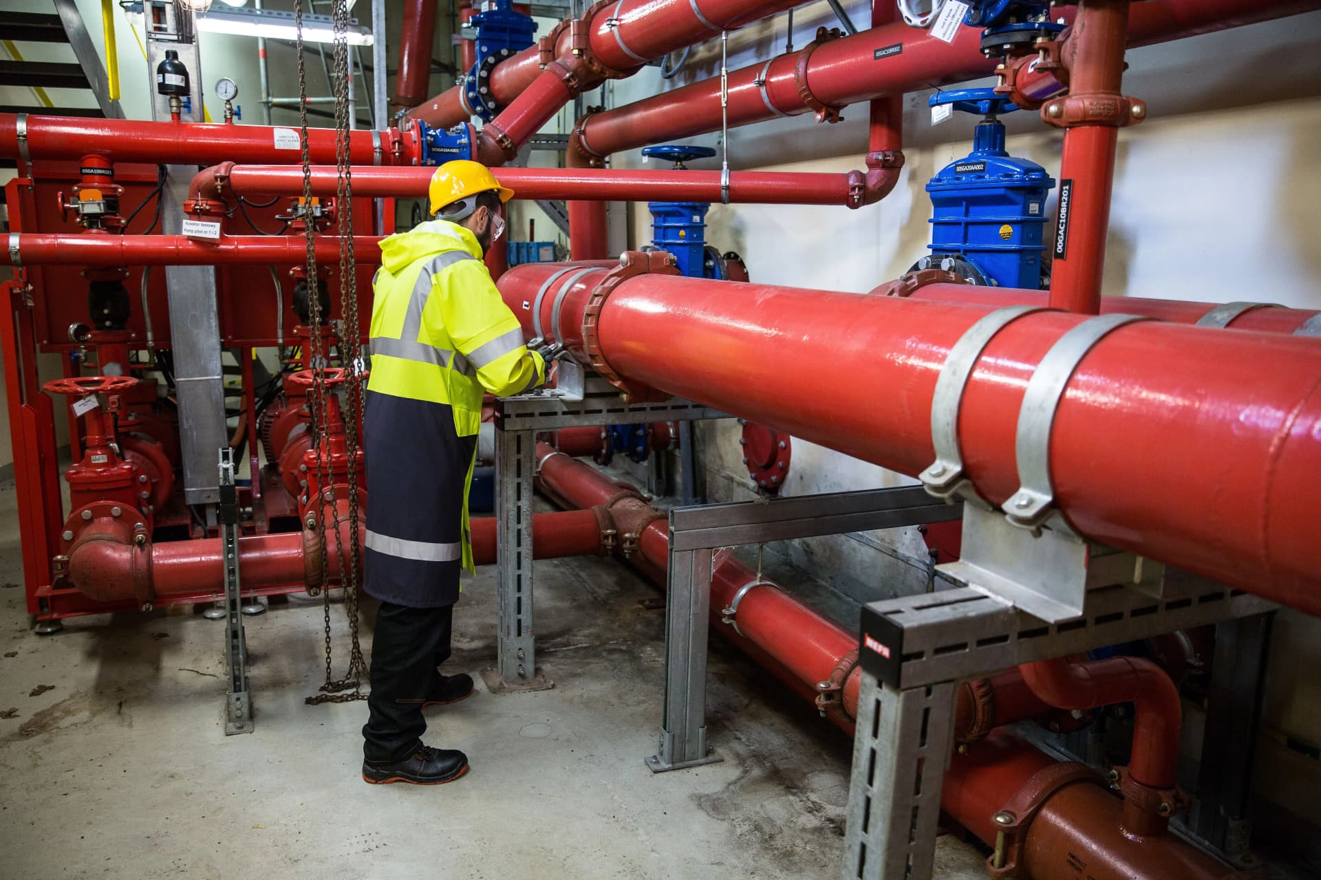 Engineer carrying out reactive maintenance repairs on commercial building services equipment