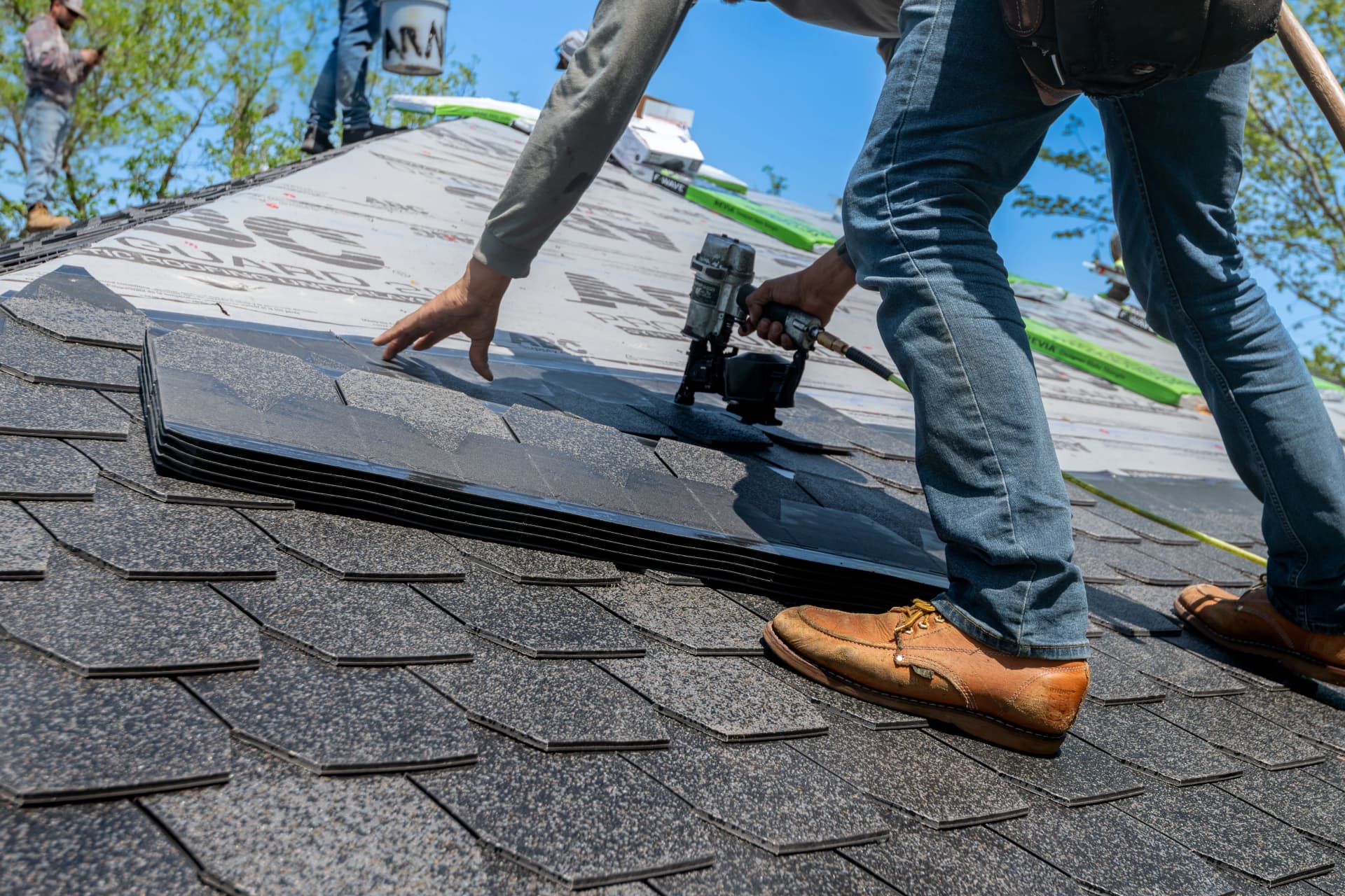 Roof ventilation features installed within a pitched roofing system