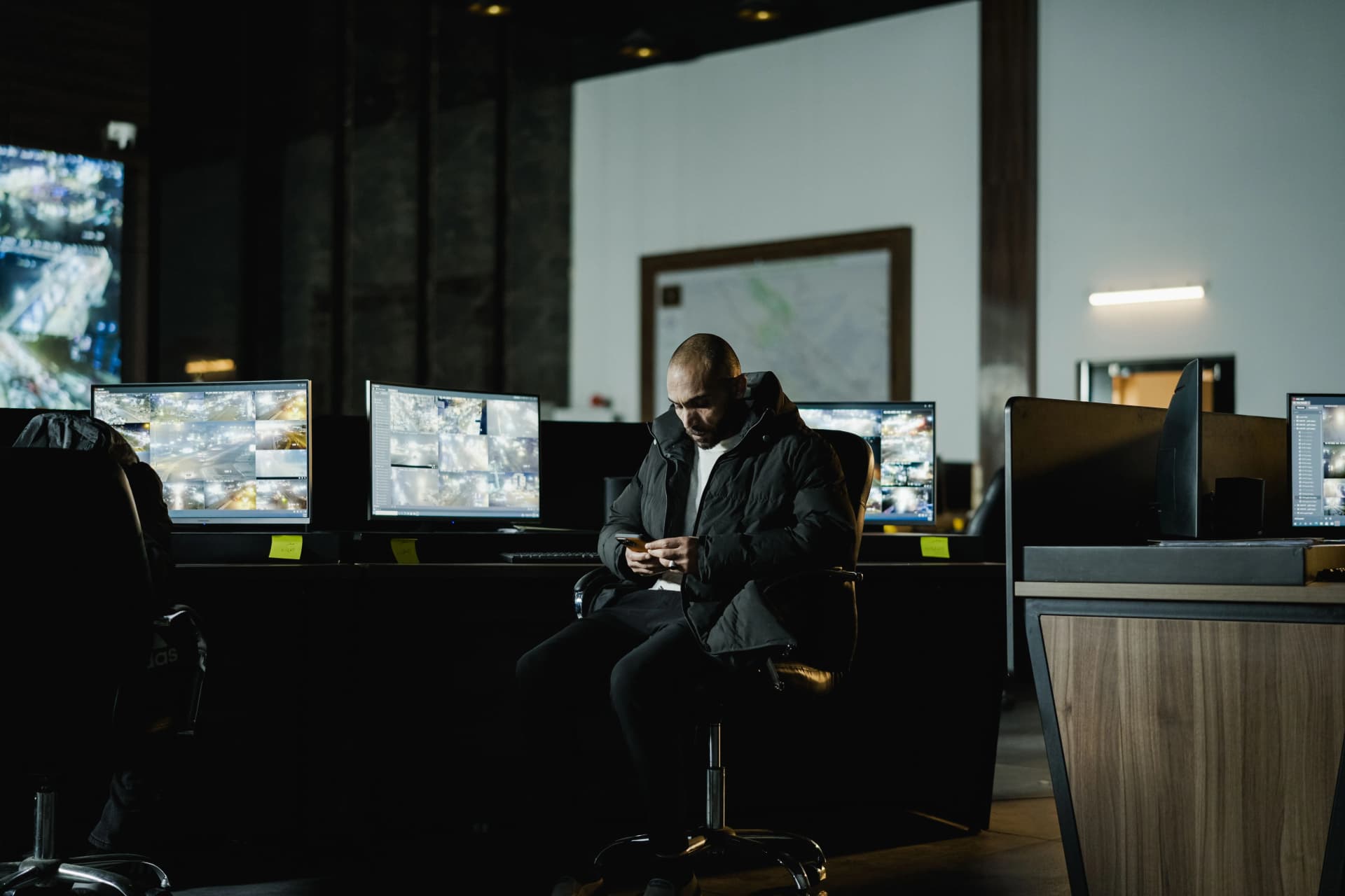 Security guard monitoring CCTV surveillance screens